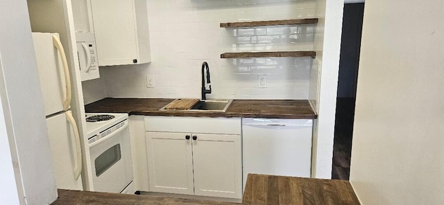 kitchen featuring tasteful backsplash, white cabinetry, sink, and white appliances