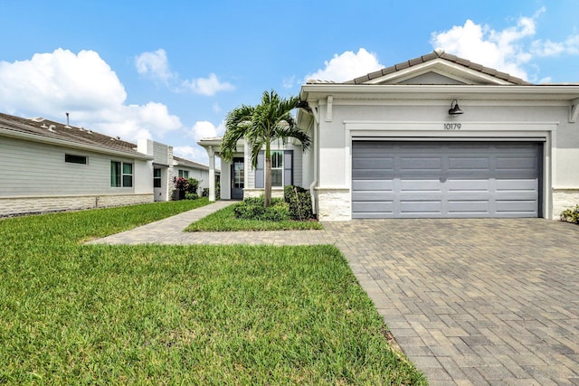 single story home with a front yard and a garage