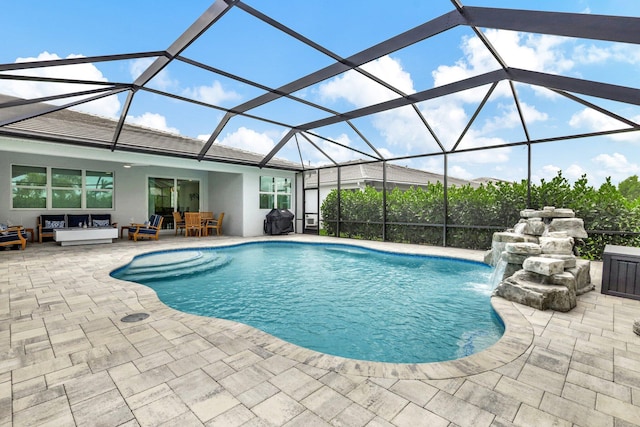 view of swimming pool featuring glass enclosure, grilling area, an outdoor hangout area, pool water feature, and a patio