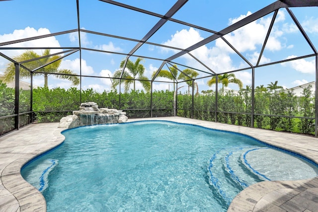 view of pool featuring a lanai, a patio area, and pool water feature