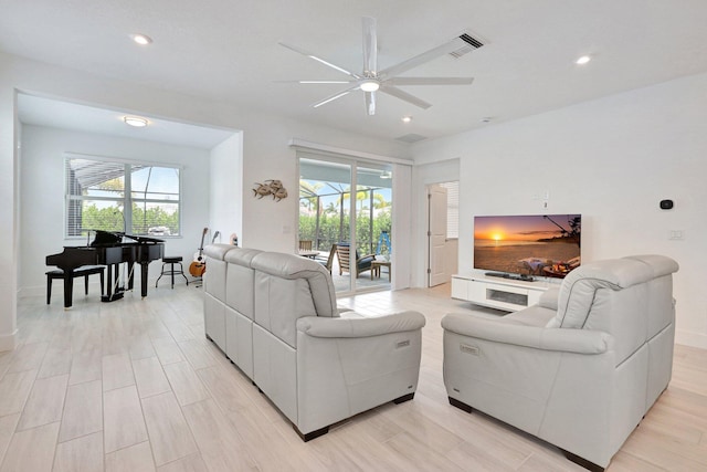 living room featuring ceiling fan and light wood-type flooring