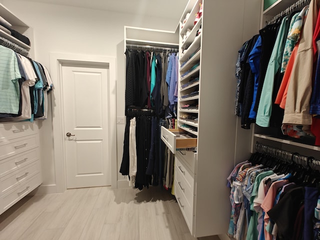 walk in closet featuring light hardwood / wood-style flooring