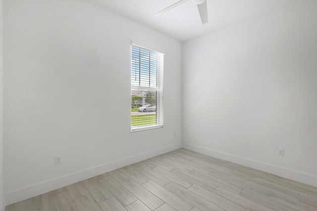 spare room with light hardwood / wood-style flooring and plenty of natural light