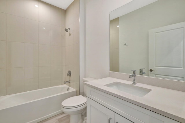 full bathroom with vanity, toilet, wood-type flooring, and tiled shower / bath