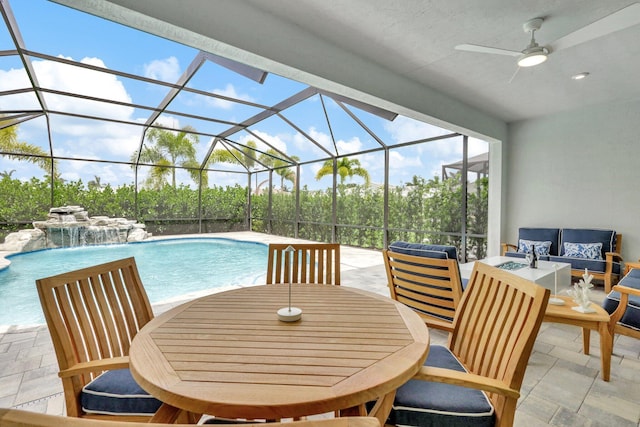 view of swimming pool featuring outdoor lounge area, pool water feature, a patio, and ceiling fan