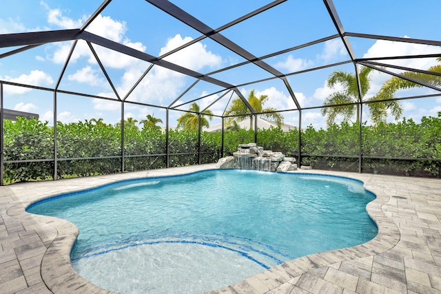 view of pool with pool water feature, a lanai, and a patio area