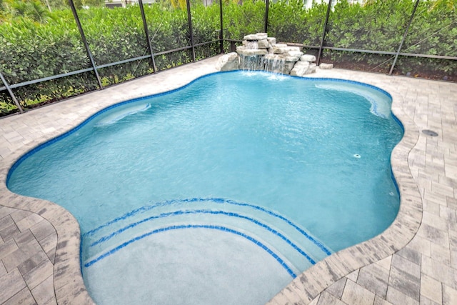 view of swimming pool with pool water feature