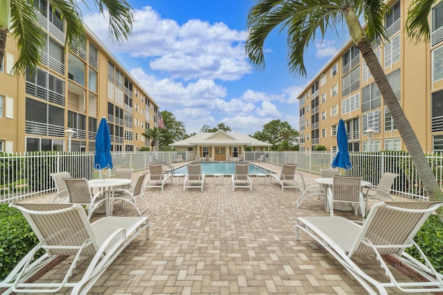 view of patio featuring fence and a community pool