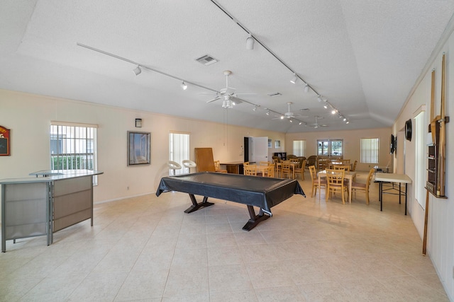 recreation room featuring a textured ceiling, light tile patterned floors, pool table, ceiling fan, and lofted ceiling