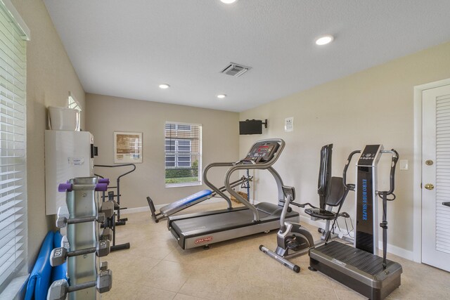 workout area featuring a textured ceiling