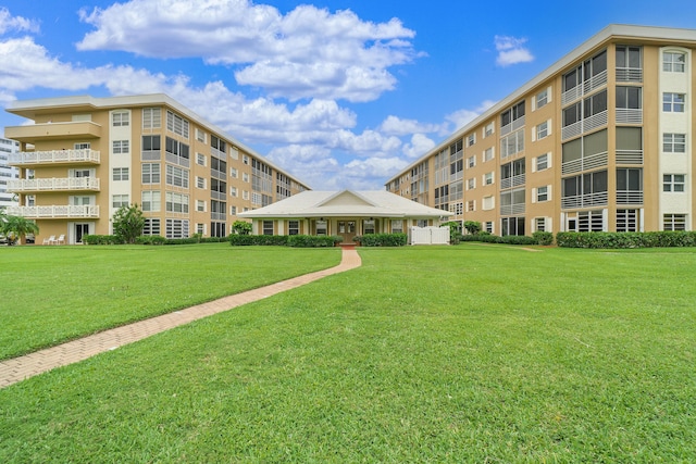 view of property's community with a lawn