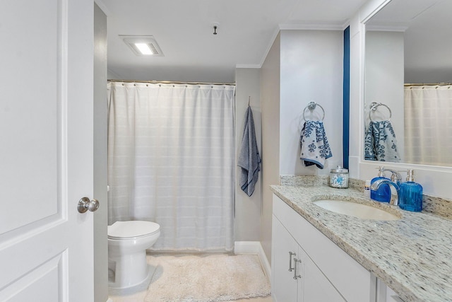 bathroom featuring crown molding, vanity, and toilet