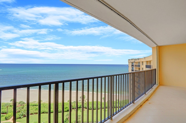 balcony with a water view and a beach view