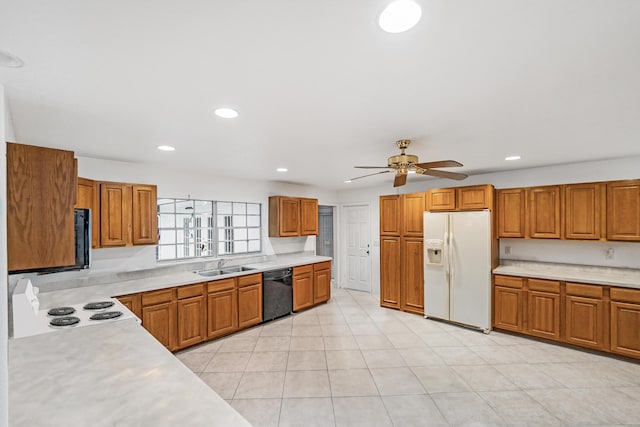 4050 Greenwood Dr, Fort Pierce, FL 34982 - kitchen featuring white appliances, light countertops, a sink, and brown cabinetry