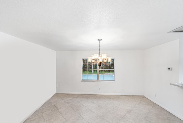 4050 Greenwood Dr, Fort Pierce, FL 34982 - empty room with a notable chandelier, baseboards, and a textured ceiling