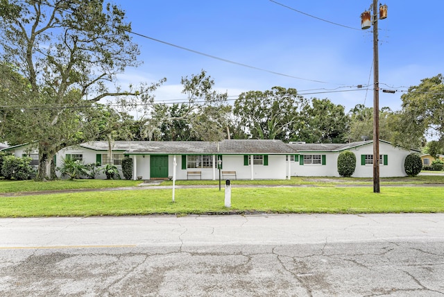 4050 Greenwood Dr, Fort Pierce, FL 34982 - view of front of house featuring stucco siding and a front lawn