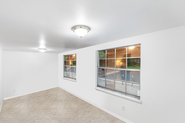 4050 Greenwood Dr, Fort Pierce, FL 34982 - tiled empty room featuring baseboards