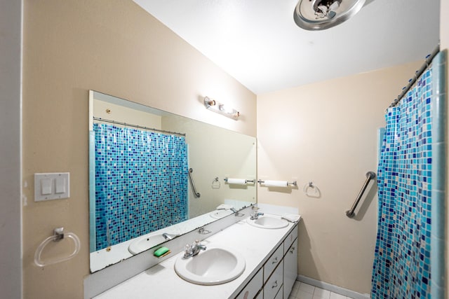 4050 Greenwood Dr, Fort Pierce, FL 34982 - full bath with double vanity, a sink, tile patterned floors, and a shower with curtain