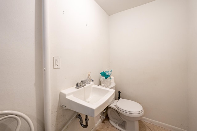 4050 Greenwood Dr, Fort Pierce, FL 34982 - bathroom featuring toilet, a sink, and tile patterned flooring