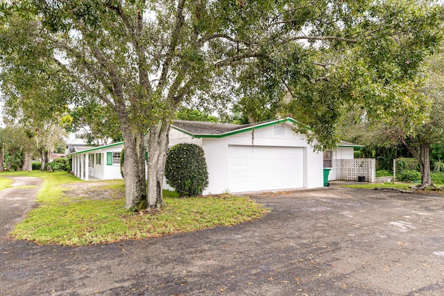 4050 Greenwood Dr, Fort Pierce, FL 34982 - view of front of home featuring a garage and aphalt driveway
