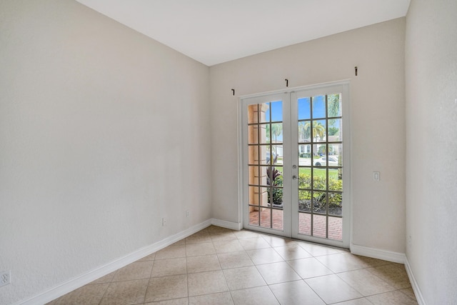 doorway with french doors and light tile patterned floors