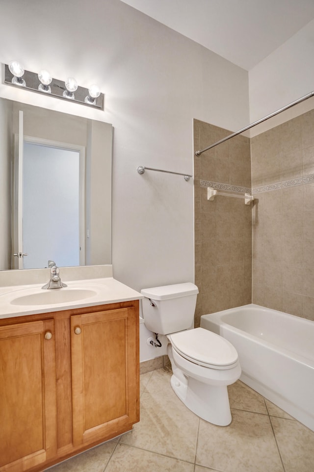 full bathroom featuring toilet, tile patterned flooring, tiled shower / bath, and vanity