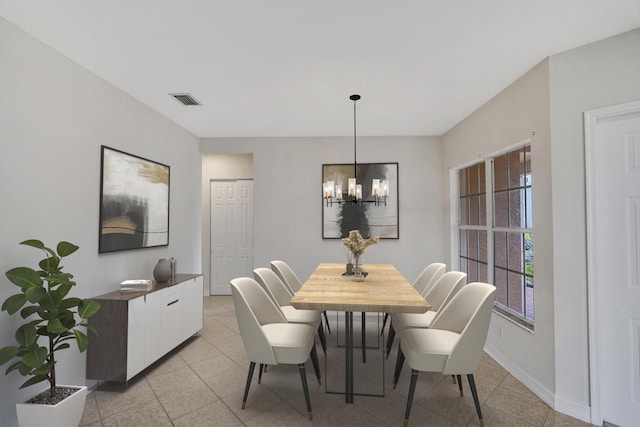 tiled dining area with an inviting chandelier