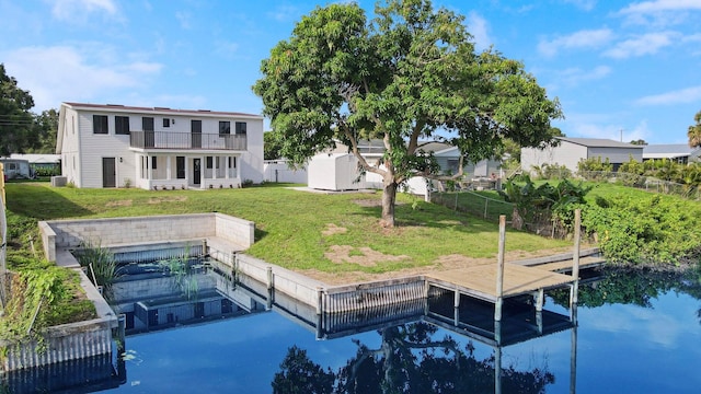 dock area with a lawn, a balcony, and central AC unit