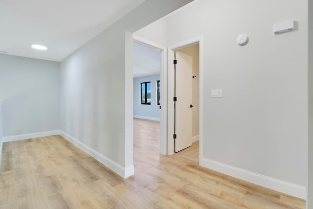 hall with light hardwood / wood-style floors