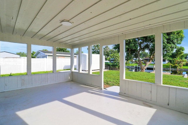 unfurnished sunroom with a water view