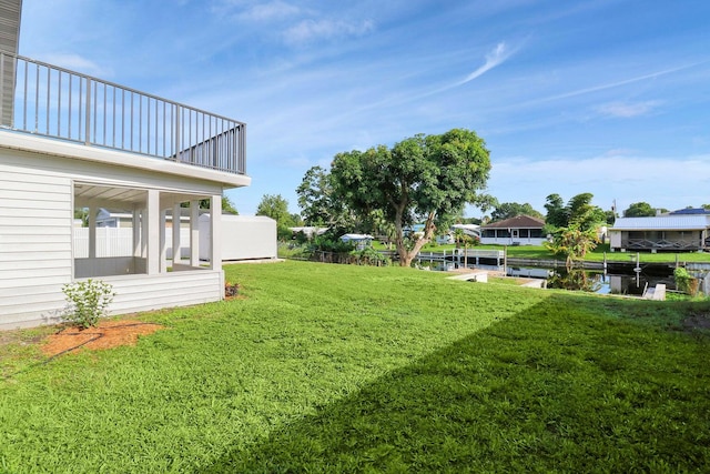 view of yard with a balcony and a water view