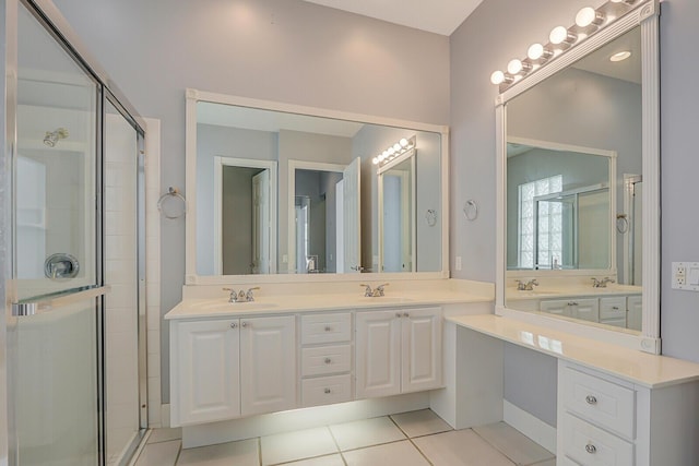 bathroom featuring tile patterned flooring, vanity, and walk in shower