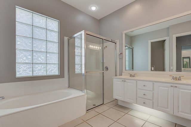 bathroom featuring tile patterned floors, vanity, and shower with separate bathtub