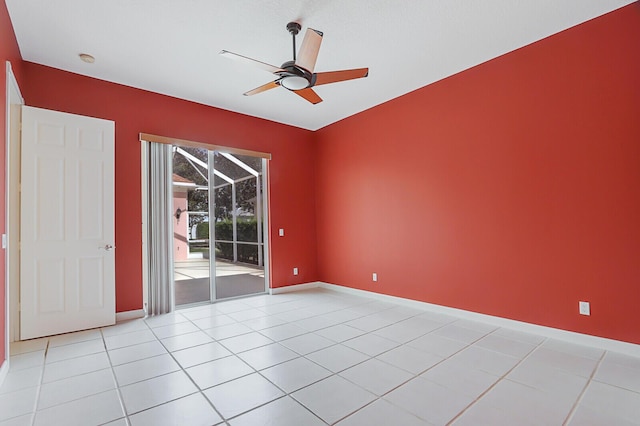 tiled empty room featuring ceiling fan