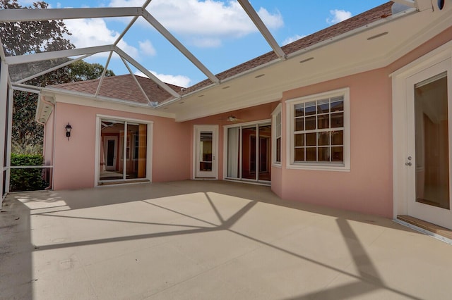 exterior space featuring glass enclosure and a patio area