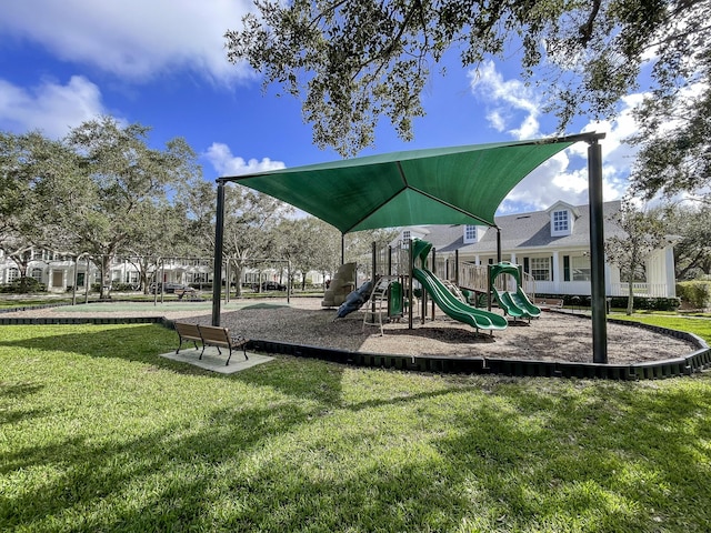 view of playground with a lawn