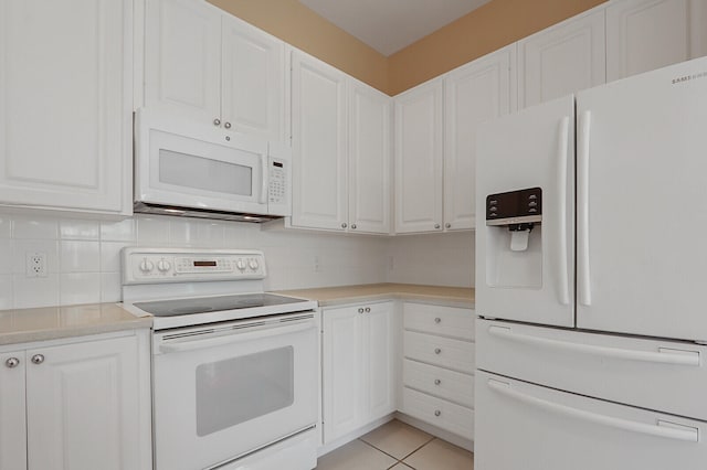 kitchen featuring backsplash, light tile patterned floors, white cabinets, and white appliances