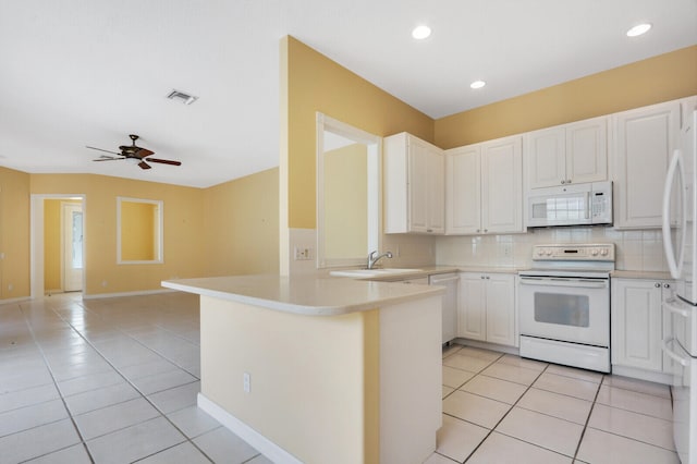 kitchen with kitchen peninsula, white appliances, white cabinets, and ceiling fan