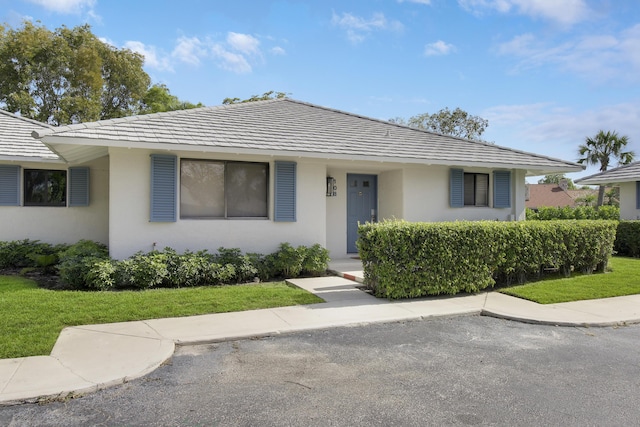 view of front facade featuring a front lawn and stucco siding