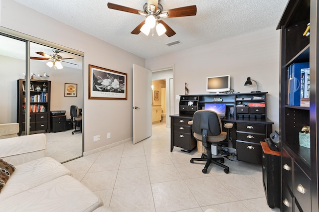 tiled home office with a textured ceiling and ceiling fan