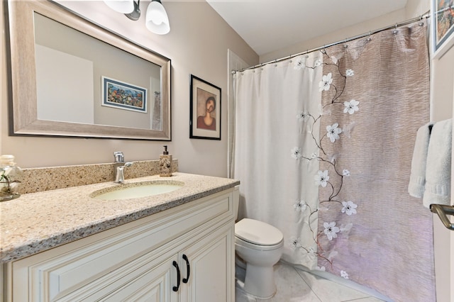 bathroom featuring tile patterned floors, vanity, and toilet