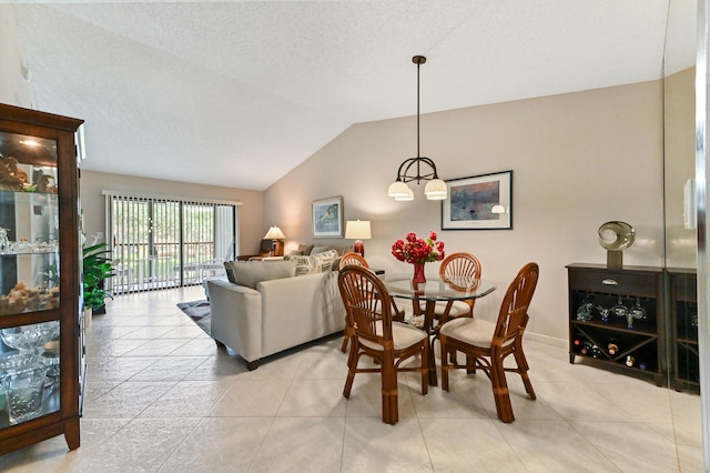 tiled dining room with vaulted ceiling