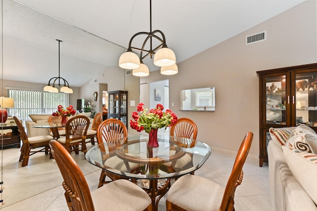 tiled dining space with vaulted ceiling