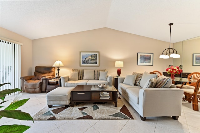 tiled living room featuring an inviting chandelier and lofted ceiling