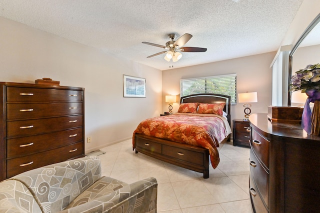 tiled bedroom with ceiling fan and a textured ceiling