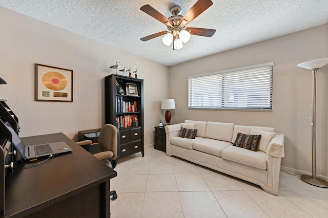 office area with ceiling fan, light tile patterned floors, and a textured ceiling