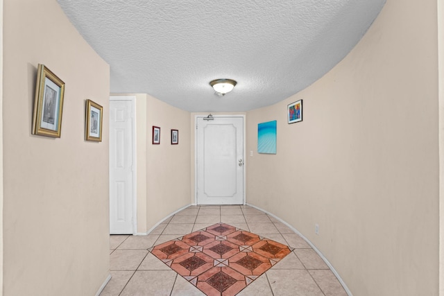 interior space with light tile patterned flooring and a textured ceiling