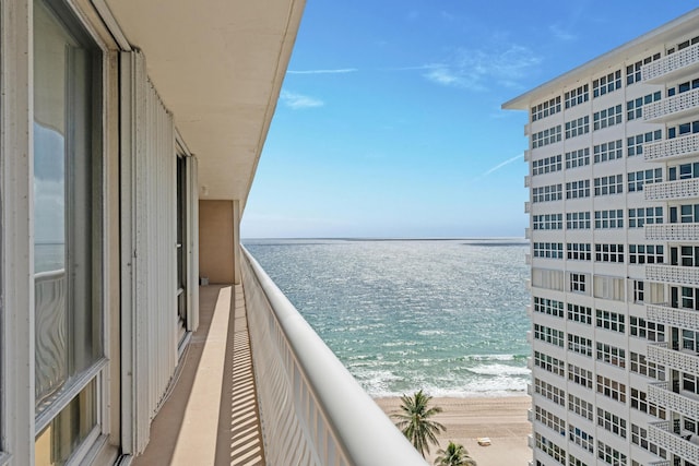 balcony with a view of the beach and a water view