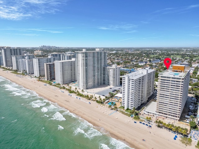 birds eye view of property featuring a view of the beach and a water view