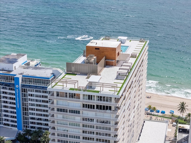 birds eye view of property with a beach view and a water view